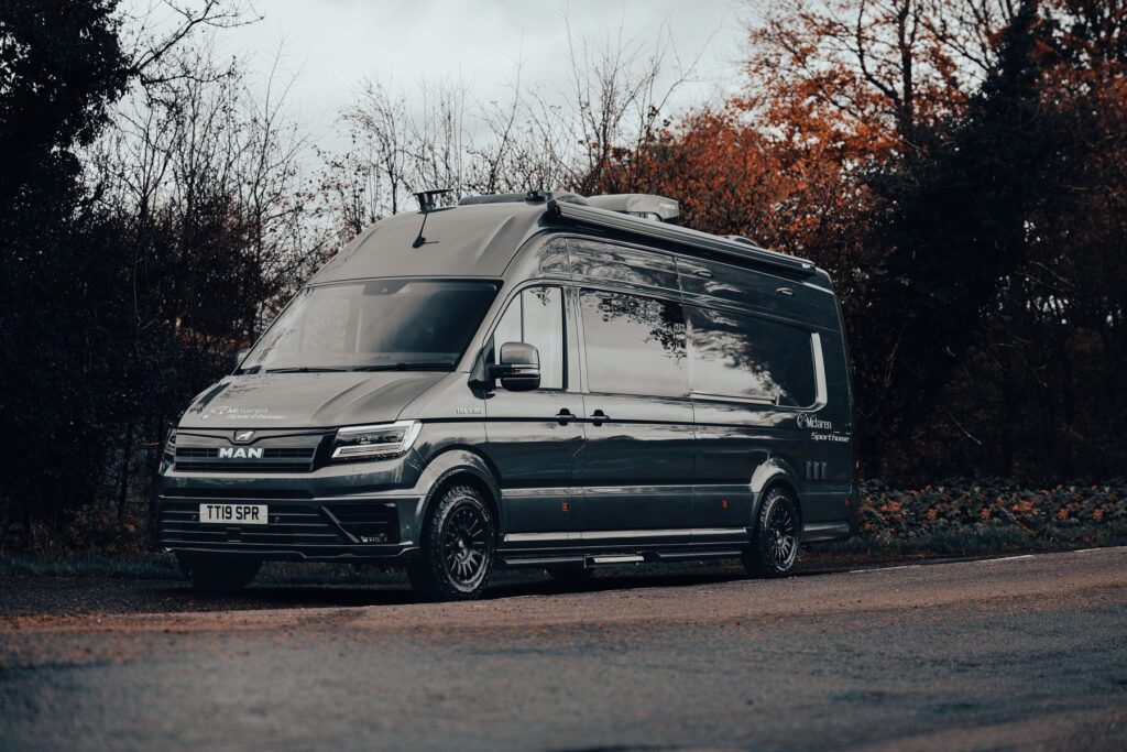 MAN TGE expedition camper conversion with roof rack and side awning