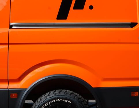 Orange van with black alloy wheels and all-terrain tyres fitted by Steadplan