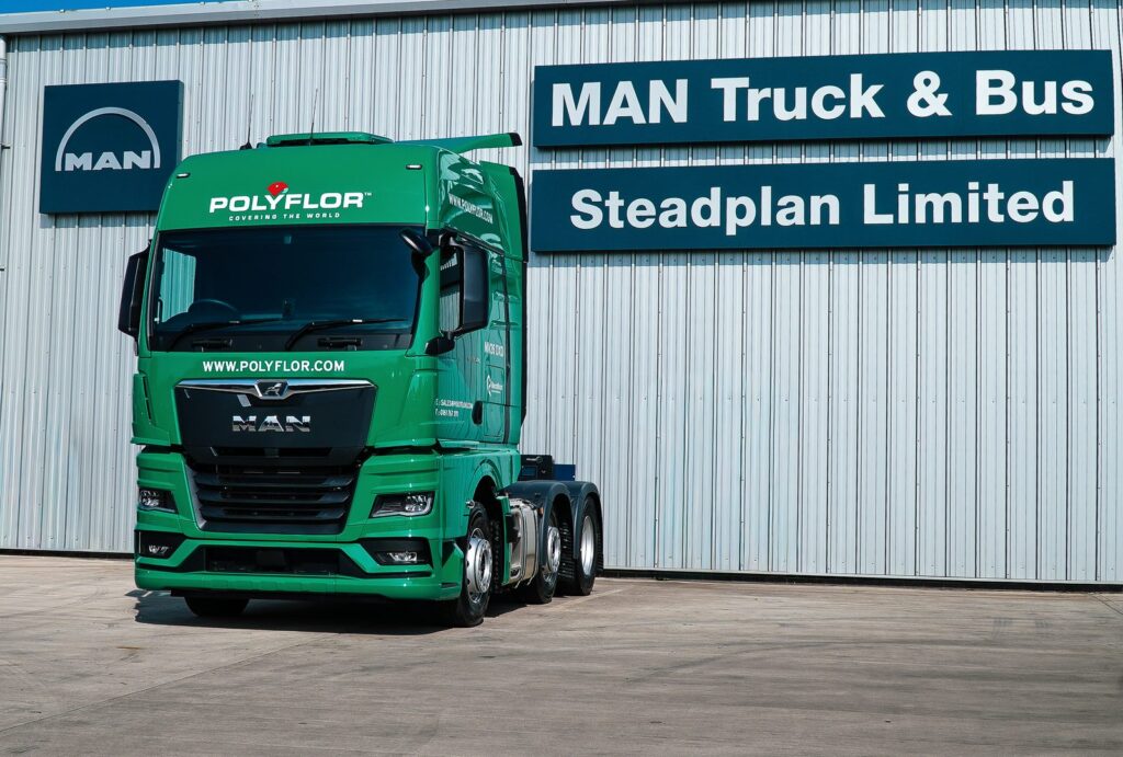 Front view of a green MAN TGX tractor unit in Polyflor livery at Steadplan