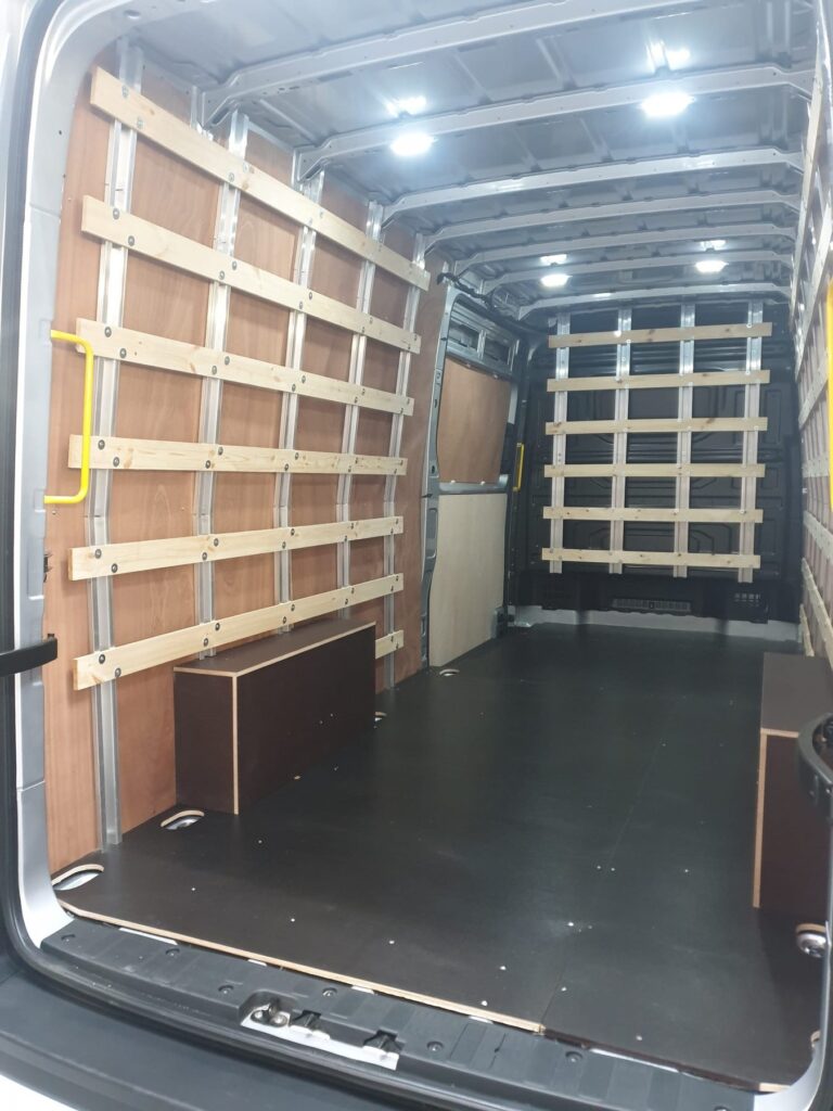 Ply lined van interior with load restraint rails